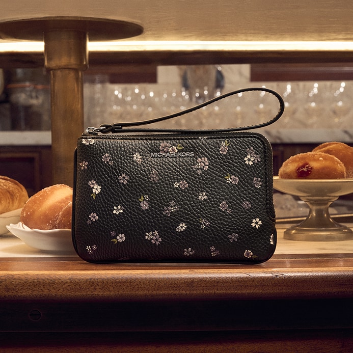 black leather handbag with floral pattern