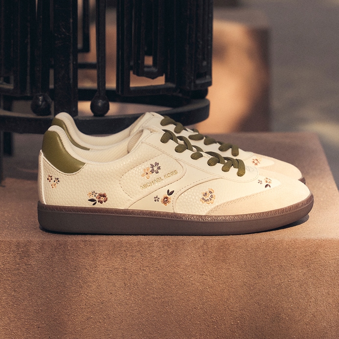 white leather sneakers with green laces and floral pattern
