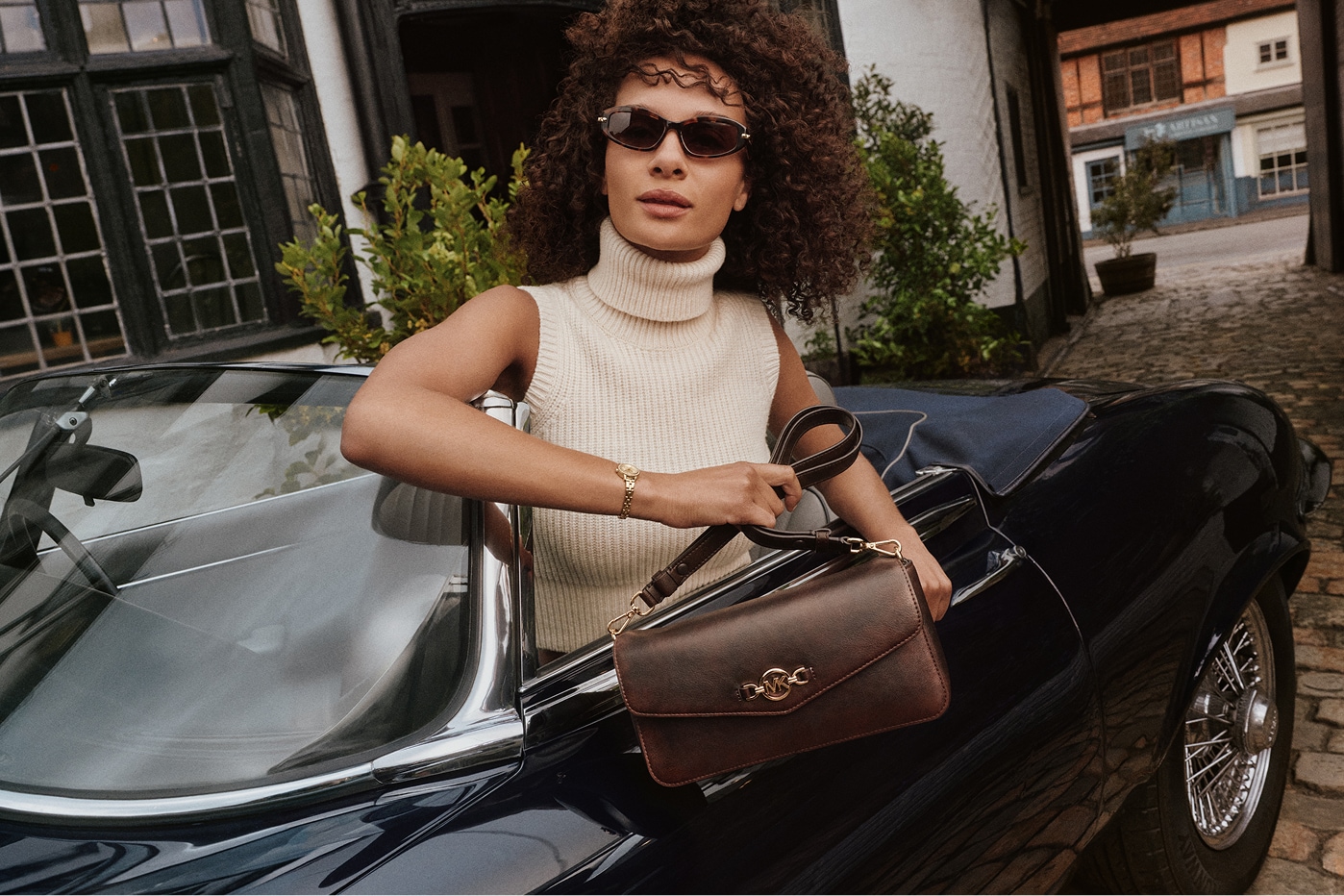 model in car holding bag
