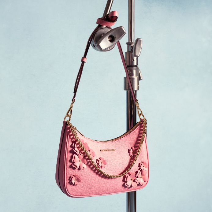 pink floral handbag on blue background