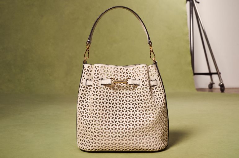cream carson handbag on green background