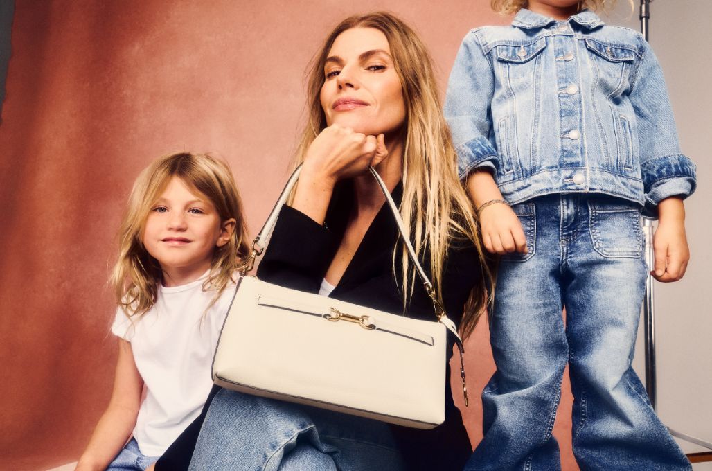 mother and children holding cream leather handbag 
