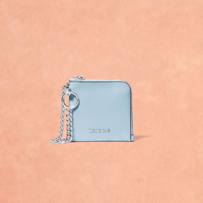 blue leather logo card case on peach background