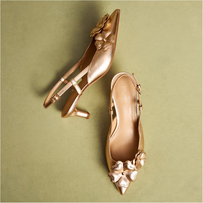 gold floral pumps on green background