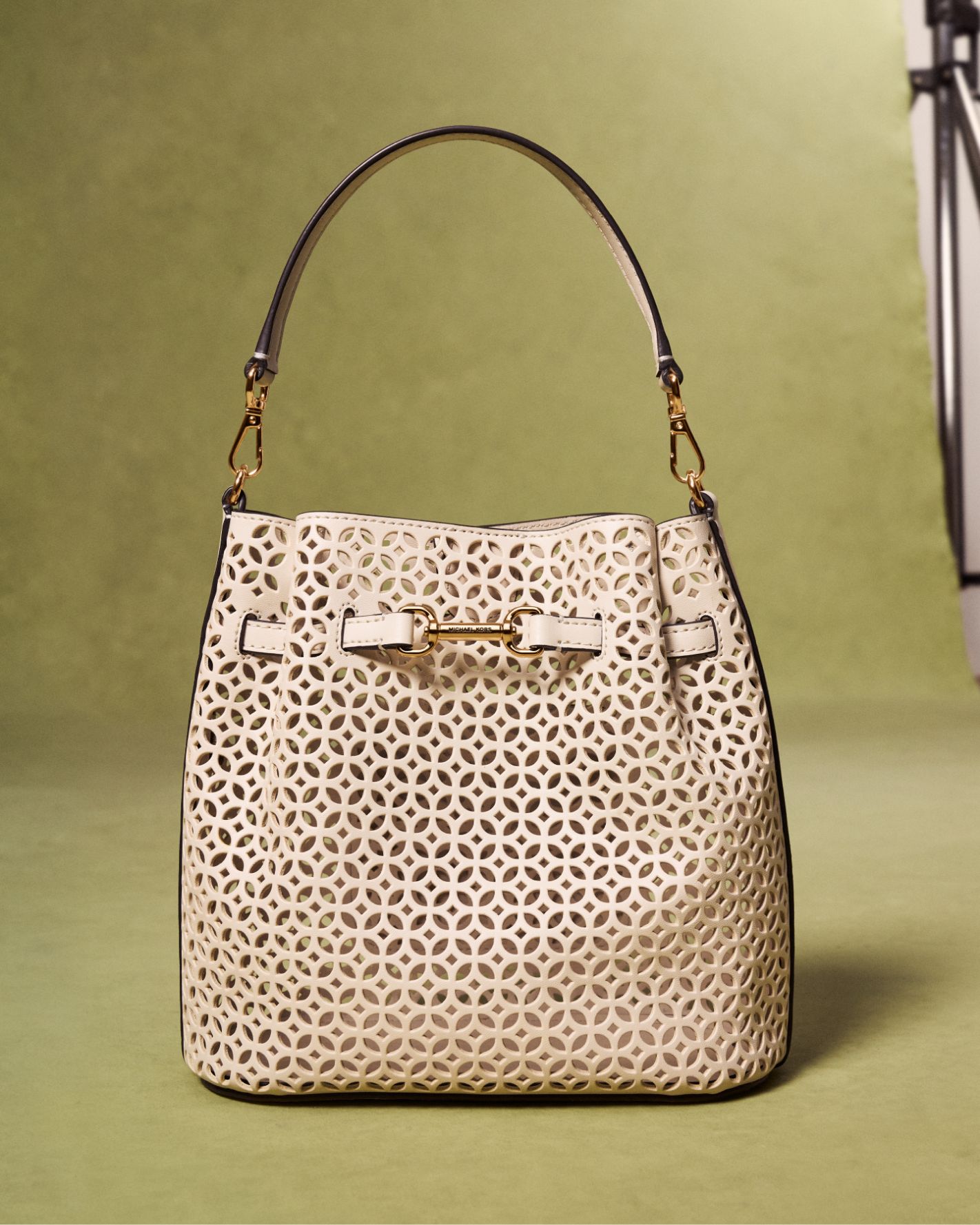 cream carson handbag on green background