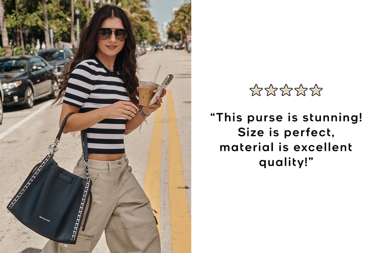 model in black and white striped shirt with black mina handbag