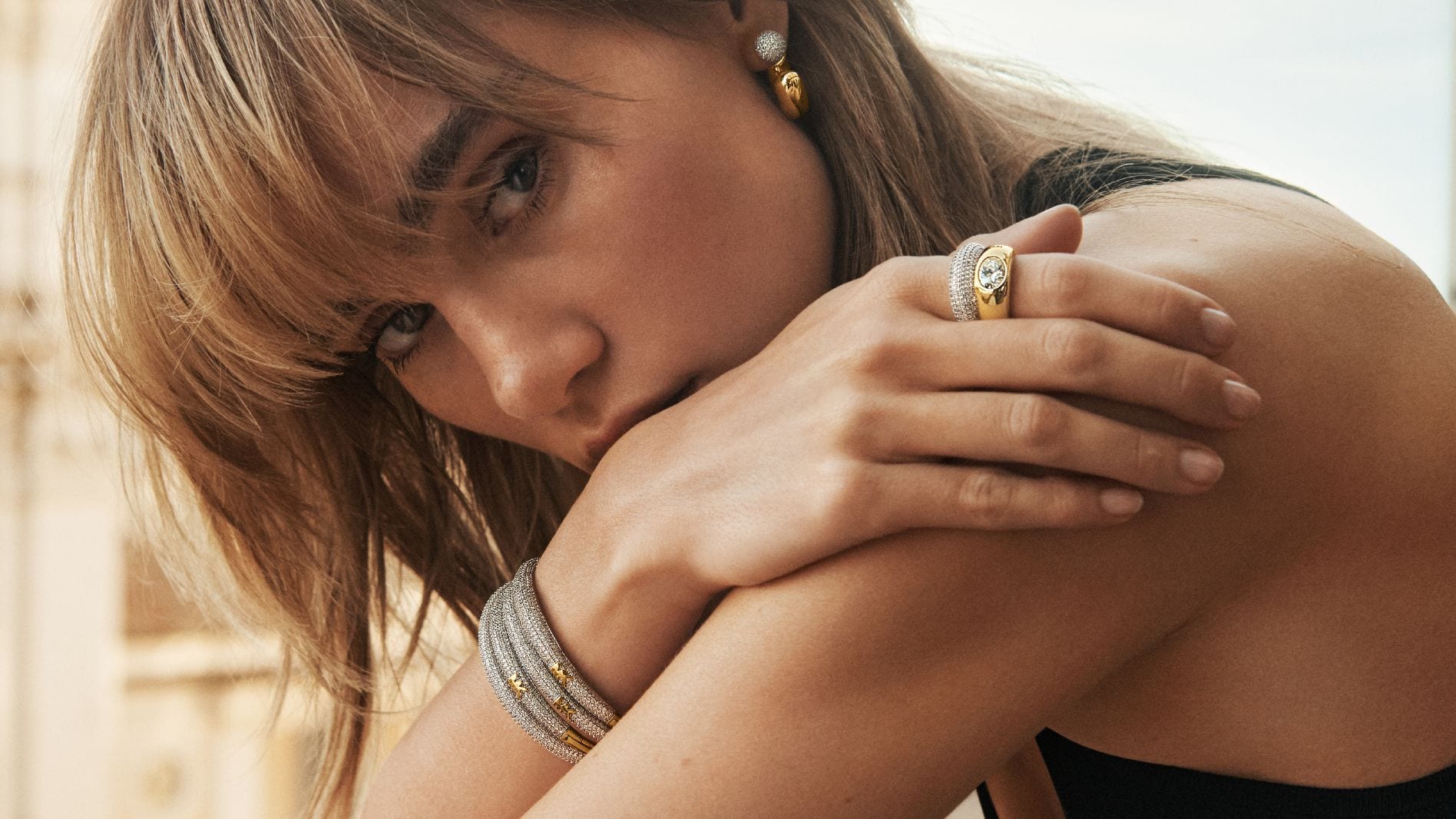 suki wearing gold and silver tone jewelry