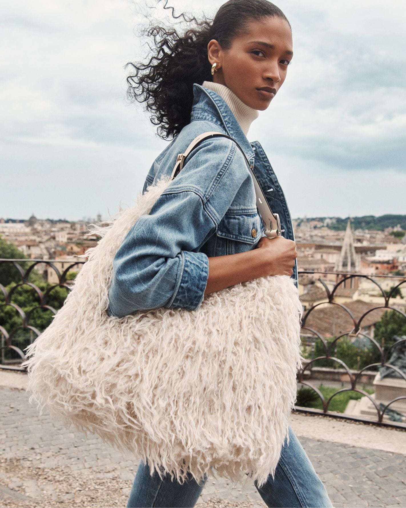 model with white faux fur shoulder bag