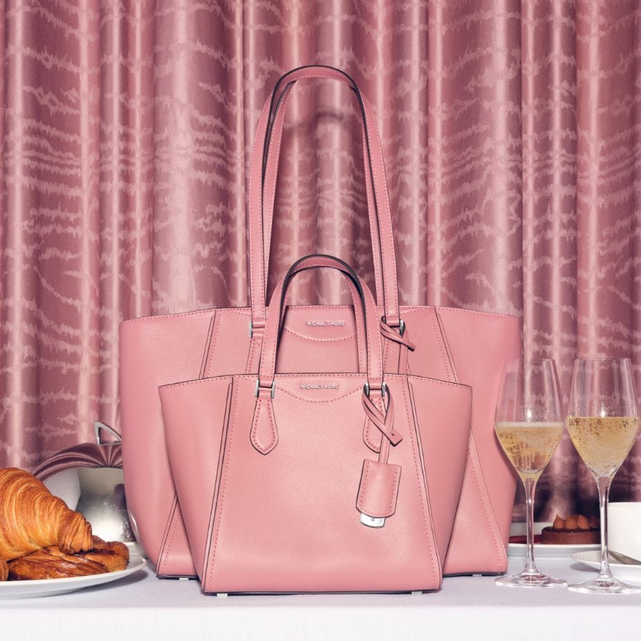 two rose pink taryn handbags on the table