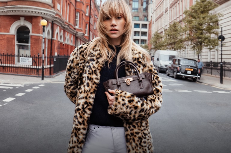 suki in leopard print fur coat