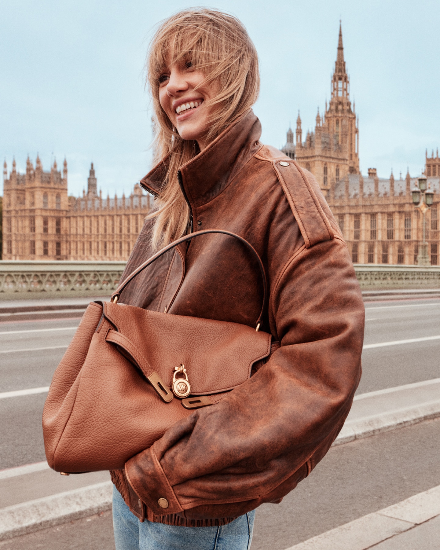suki waterhouse wearing leather bomber jacket and brown leather hamilton handbag