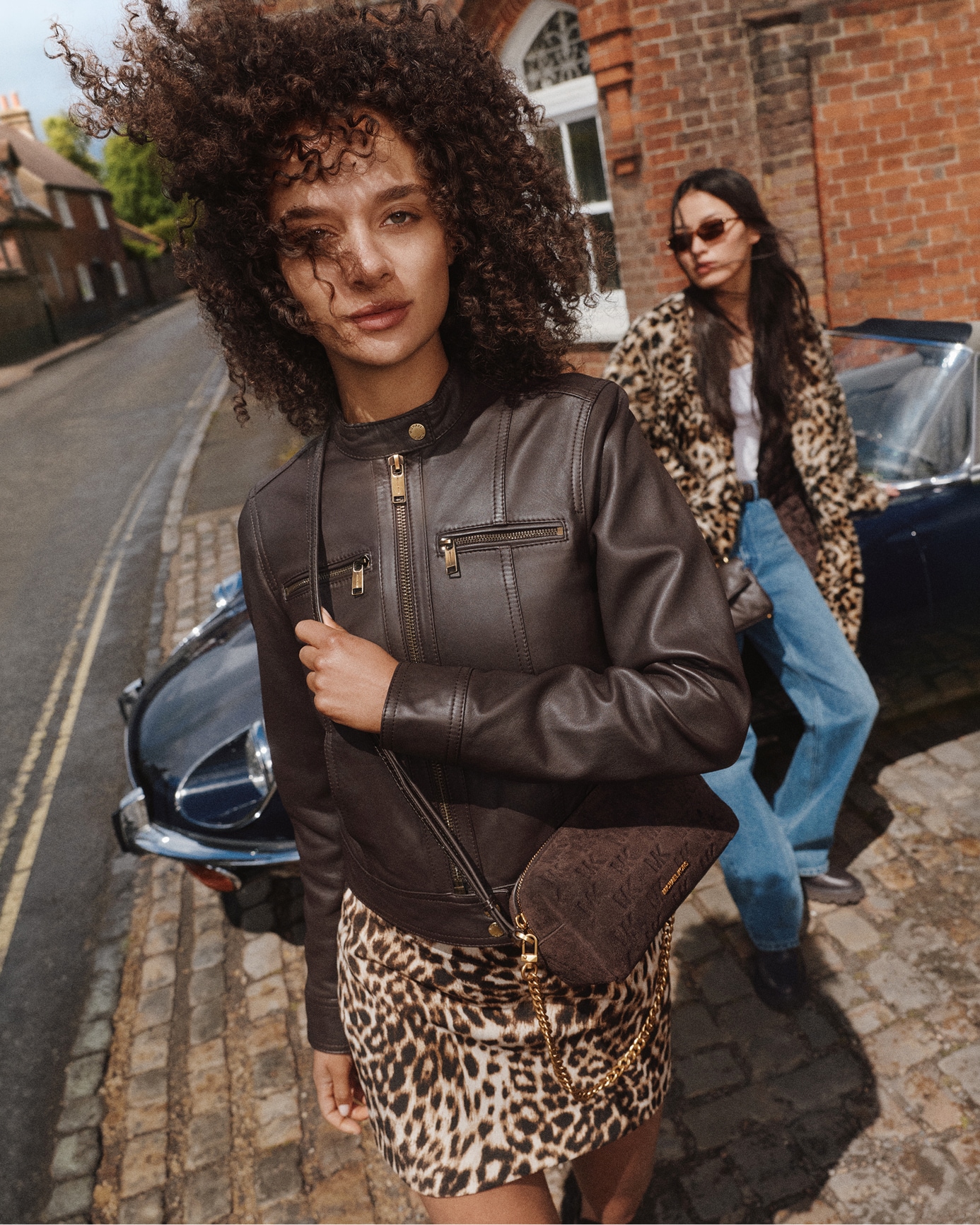 fall outfit with leather jacket and leopard print dress