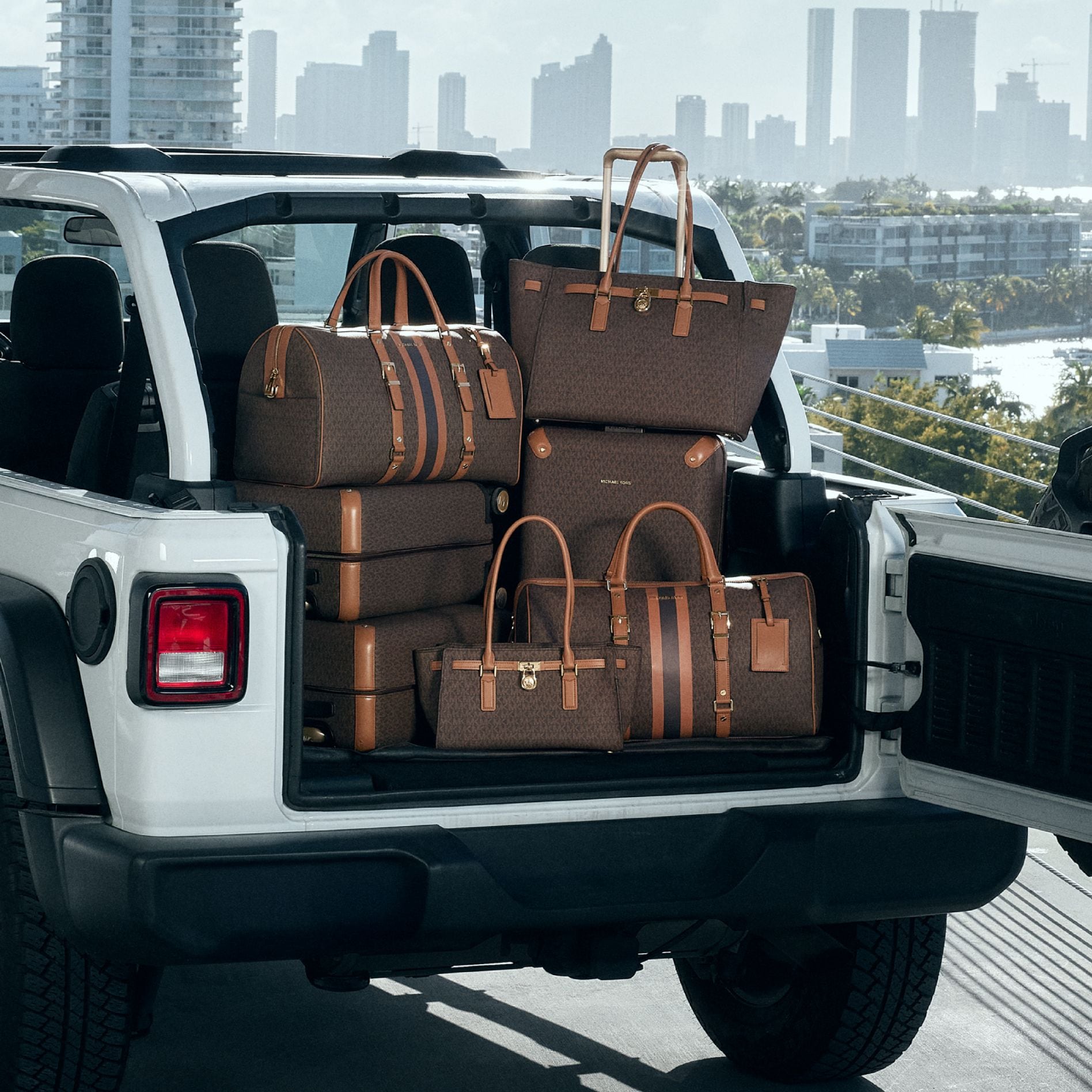 signature print luggage in trunk of car