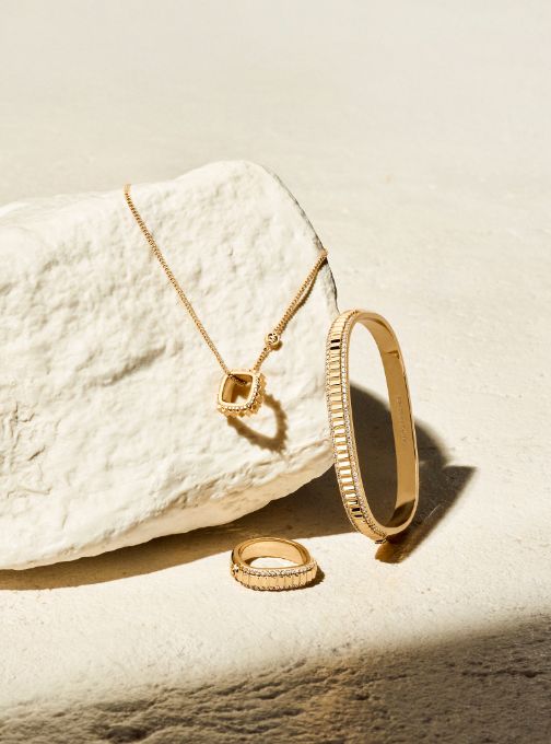 gold necklace, ring, and bracelet