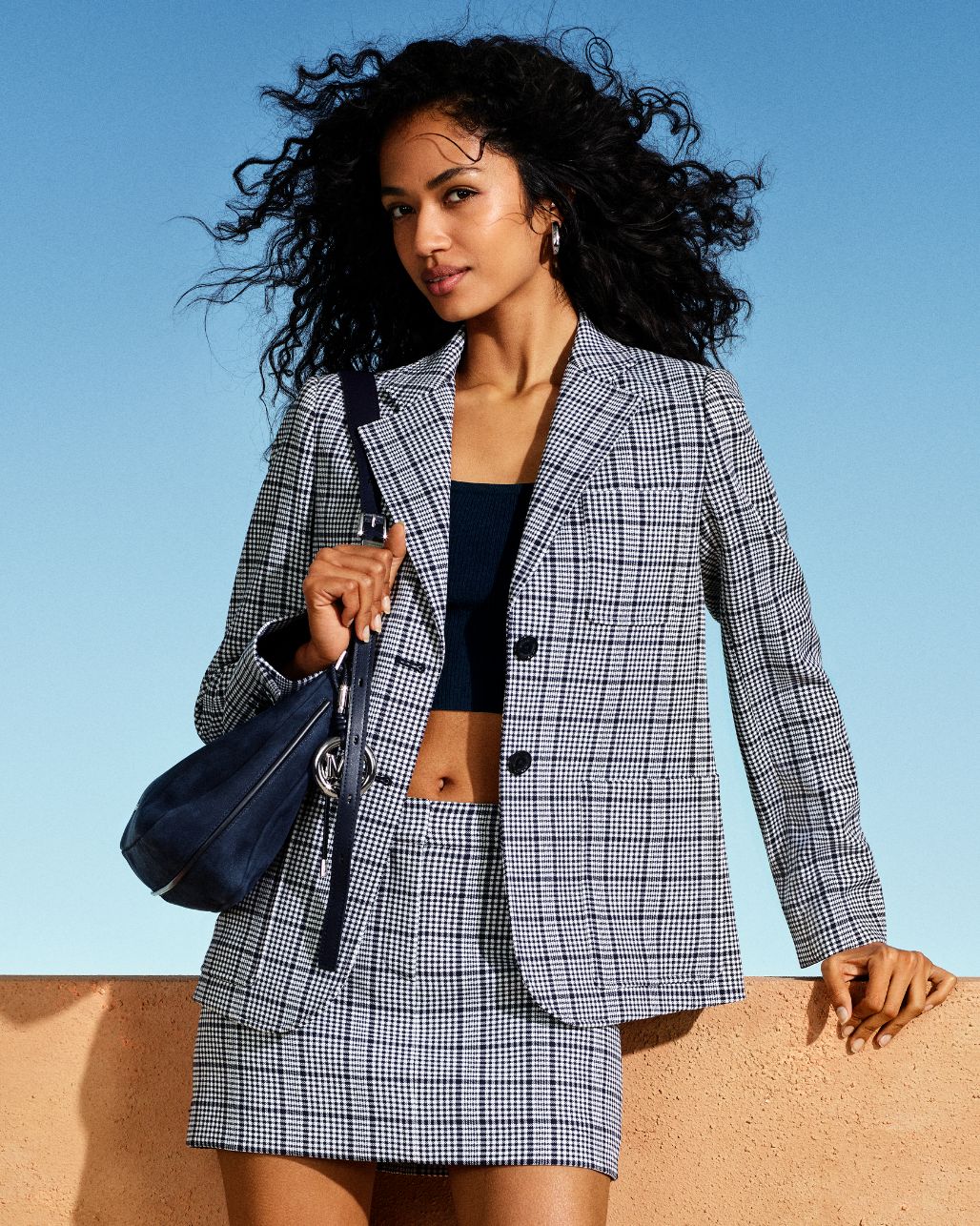 model in plaid blazer and mini skirt