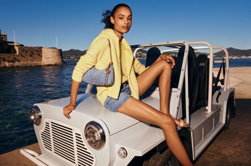 model wearing yellow hoodie and denim nolita shoulder bag