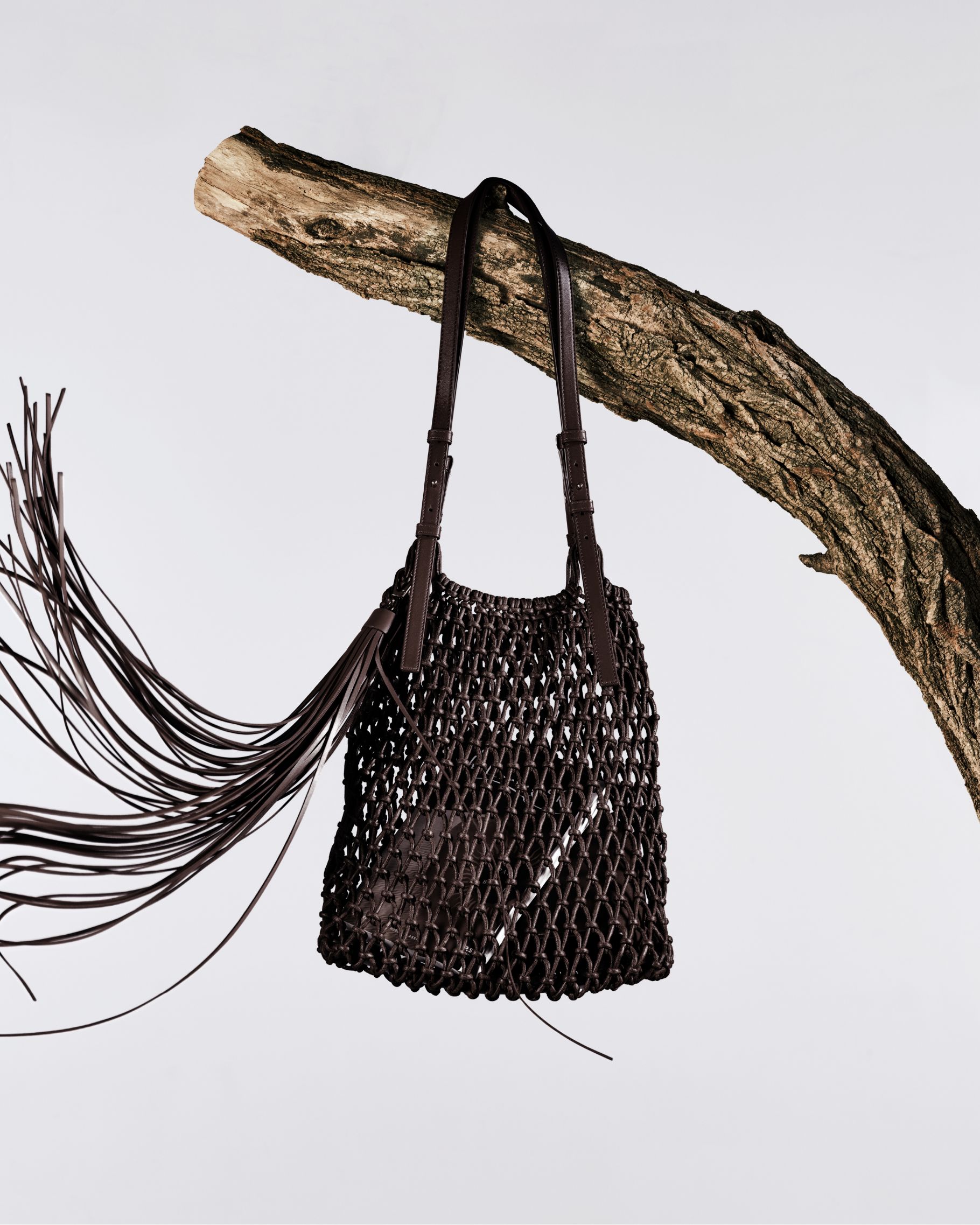 brown woven handbag with fringe