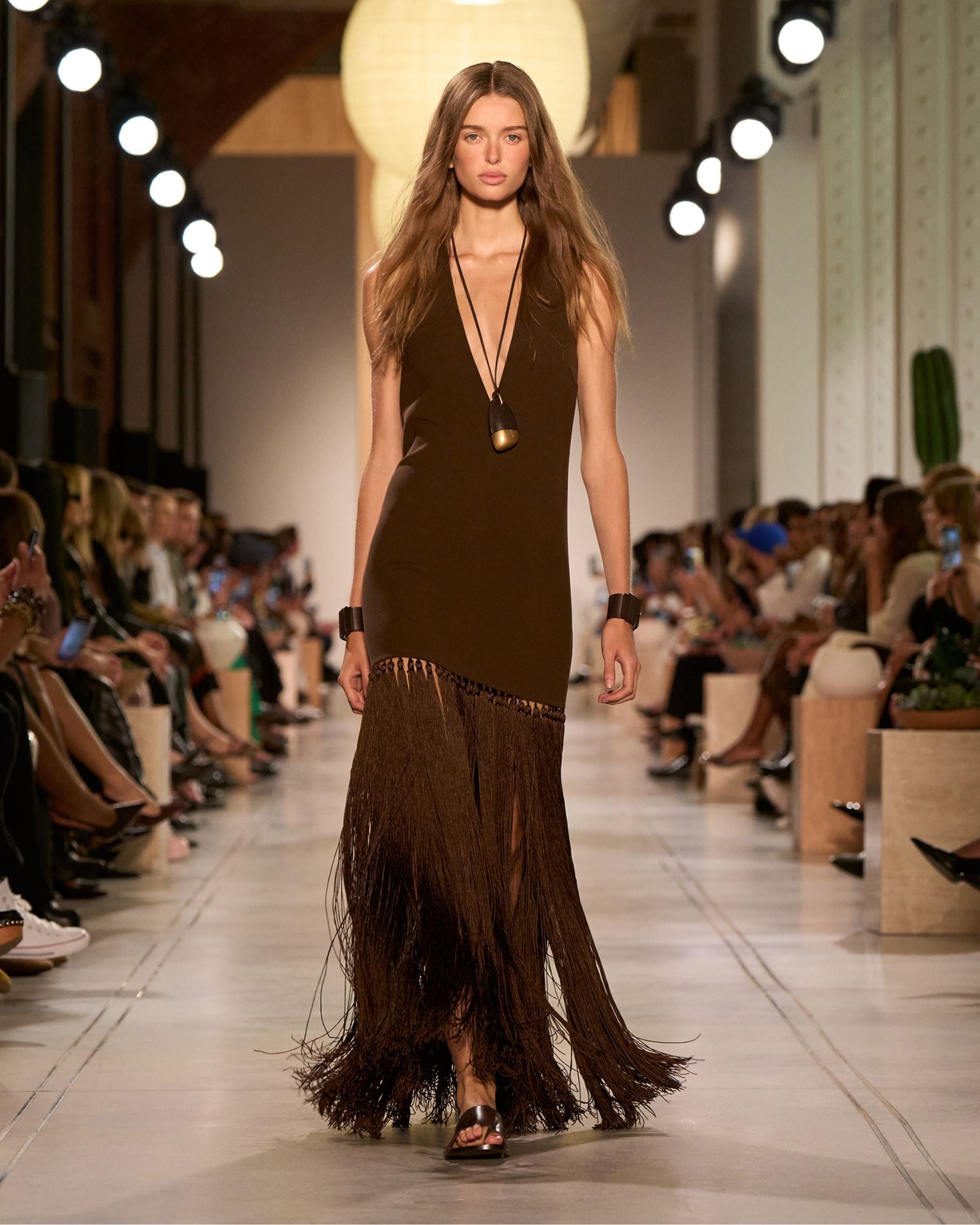 model in brown fringe dress