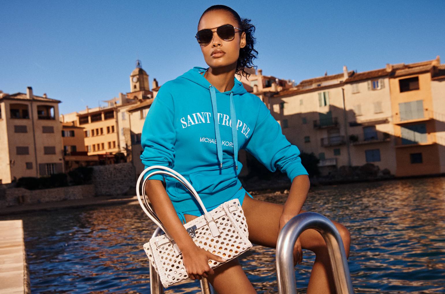 model with woven hamilton satchel