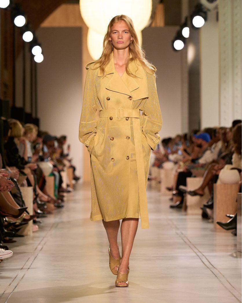 model in gold trench coat