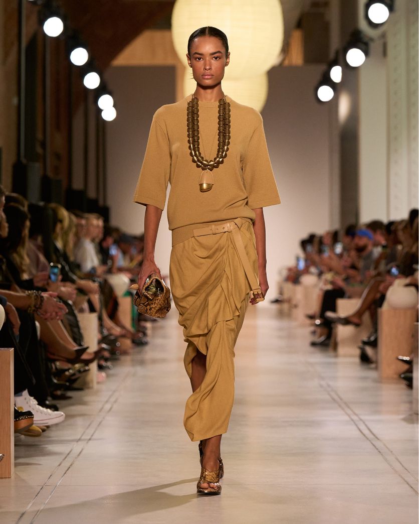 model with gold beaded necklace